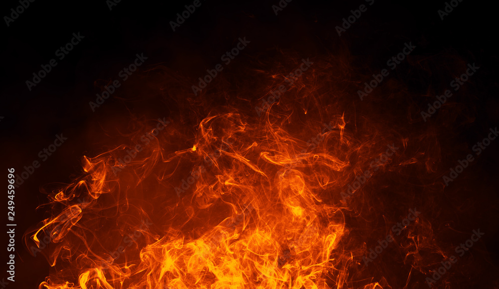 Obraz premium Texture of burn fire with particles embers. Flames on isolated black background. Texture for banner,flyer,card