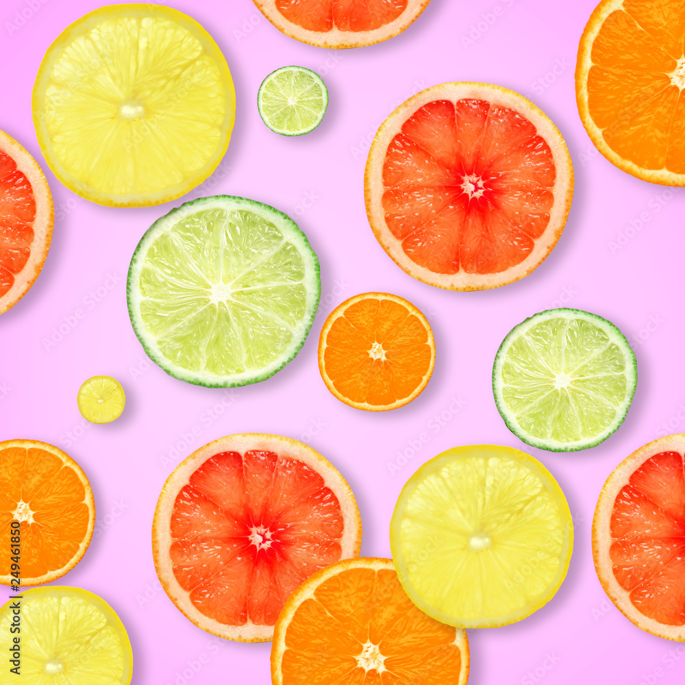 Fototapeta premium Slices of fresh citrus fruits on color background