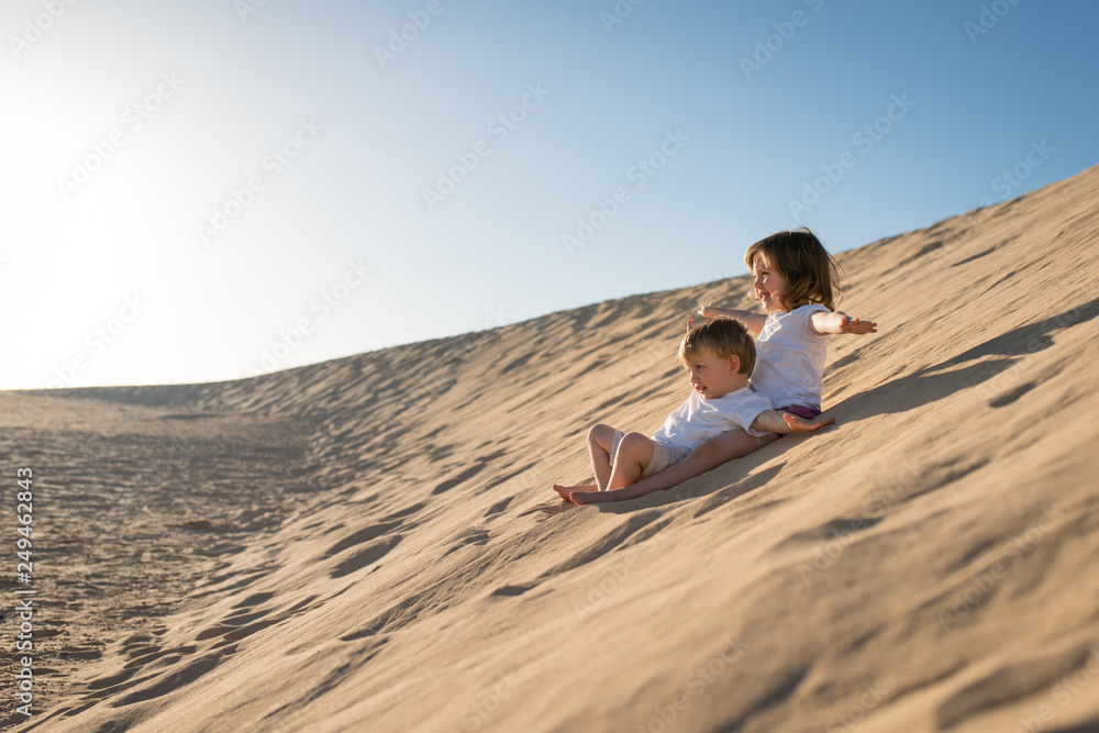 Children having fun on the sand dune