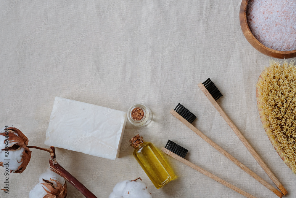 Plastic free products and bamboo toothbrush - creative layout on cotton background. Eco natural skin care concept.