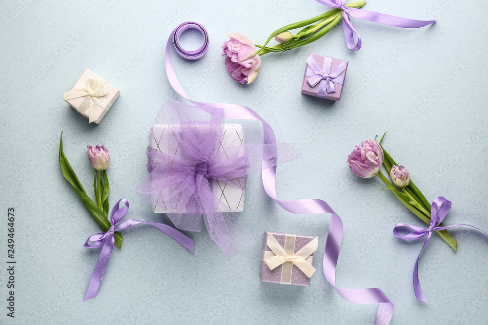 Beautiful gifts and flowers on light background Beautiful gifts and flowers on light background