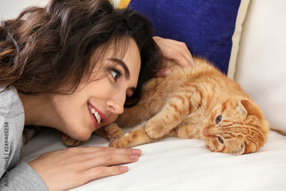 Young woman with cute funny cat at home Young woman with cute funny cat at home