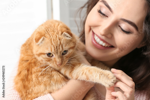 Happy Woman Cuddling Orange...