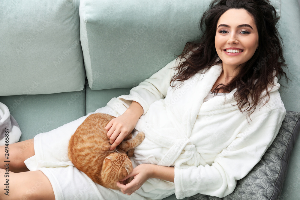 Young woman with cute funny cat at home