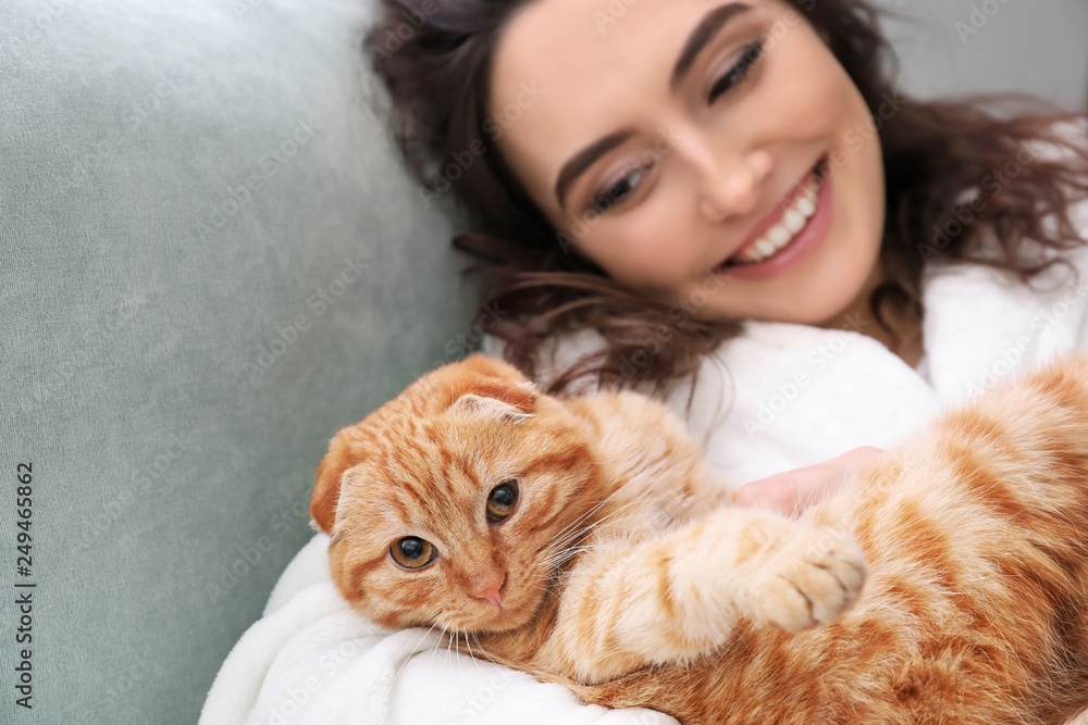 Young woman with cute funny cat at home Young woman with cute funny cat at home