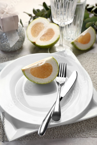 Beautiful table setting with citrus fruit