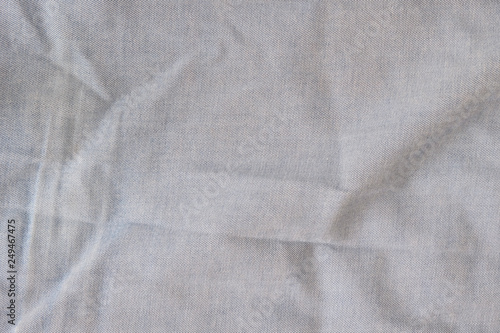 Texture of old rumpled shabby jeans, background.