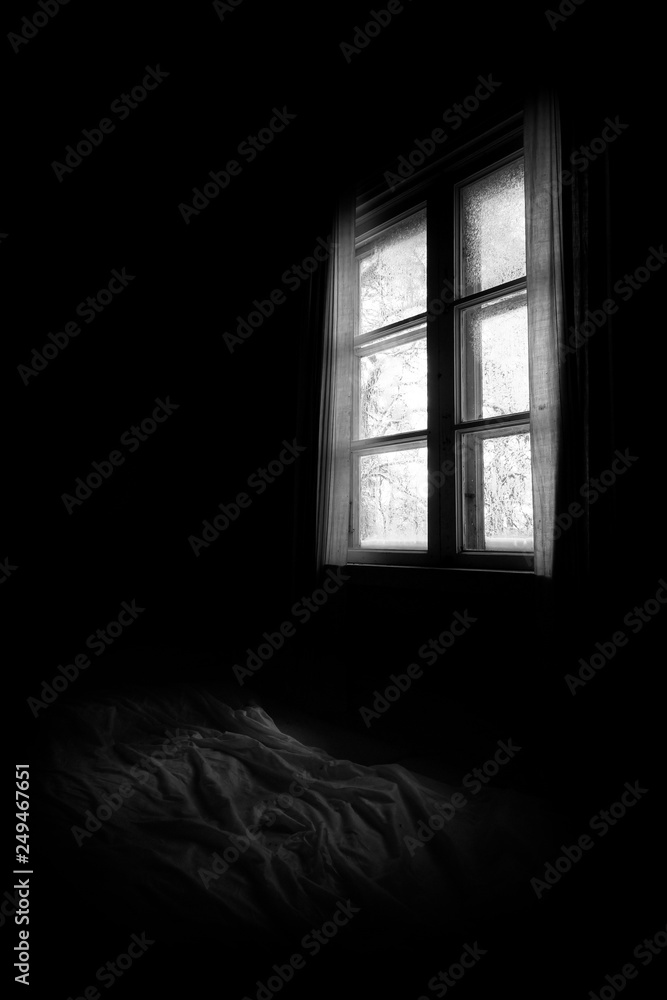 Bed and window in old, abandoned villa at gloomy winter day in Finland. Bed and window in old, abandoned villa at gloomy winter day in Finland.