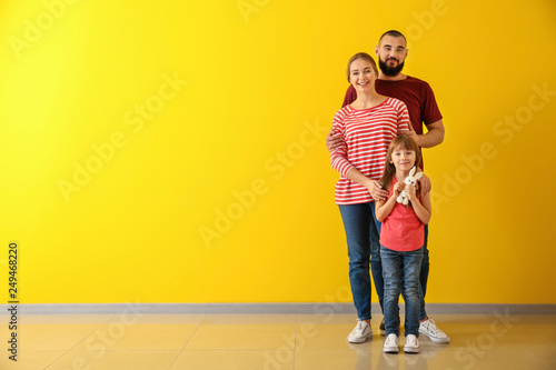 Happy family near color wall