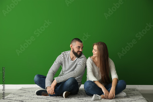 Young couple sitting on car...