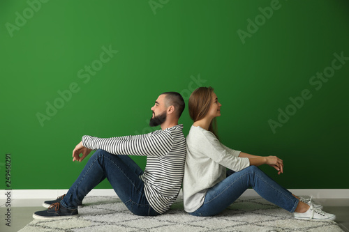 Young couple sitting on car...