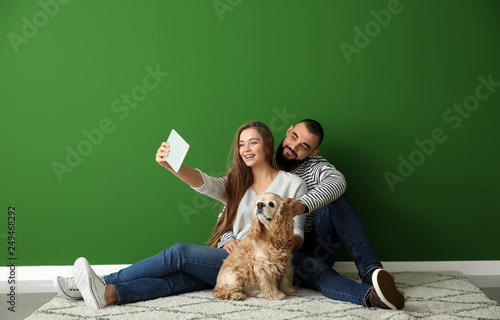 Young couple with dog takin...