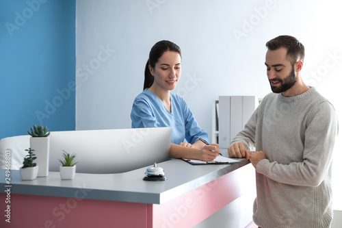 Young man near reception de...