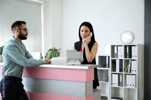 Young man at reception desk...