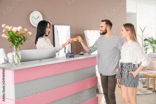 Female receptionist receivi...