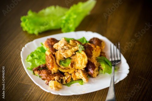 fried omelet with meat and greens in a plate