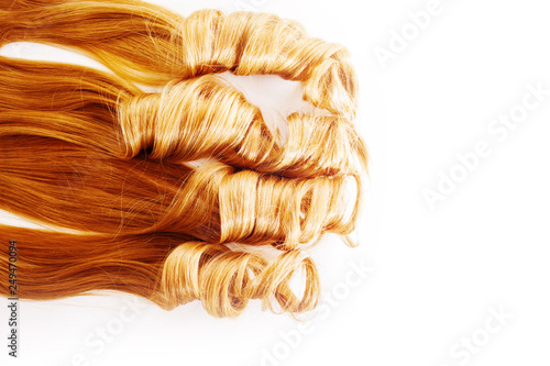 Curls curled on the Curling iron, isolated on white background. strand of light or red hair, hair care