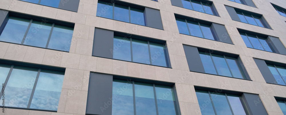modern mirror windows building with sky and clouds reflection . modern mirror windows building with sky and clouds reflection .