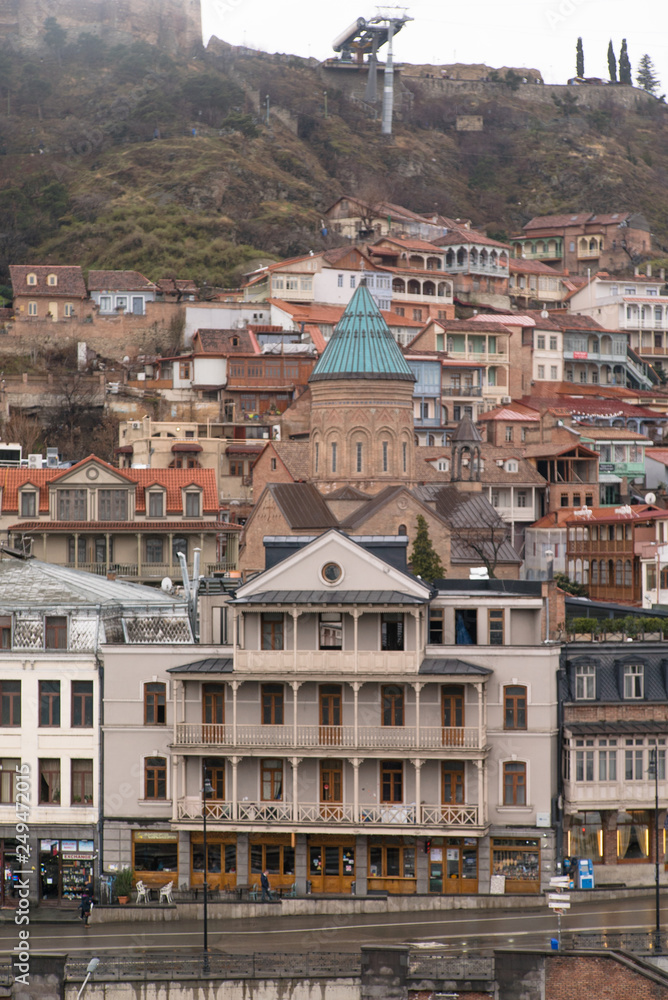 Streets and houses in Tbilisi the day. Old town.  georgia 2019. people, cars, hills, old beautiful buildings located on the hill and near the river