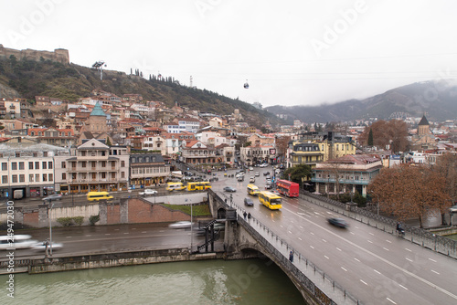 Streets and houses in Tbilisi the day. Old town. georgia 2019. people, cars, hills, old beautiful buildings located on the hill and near the river
