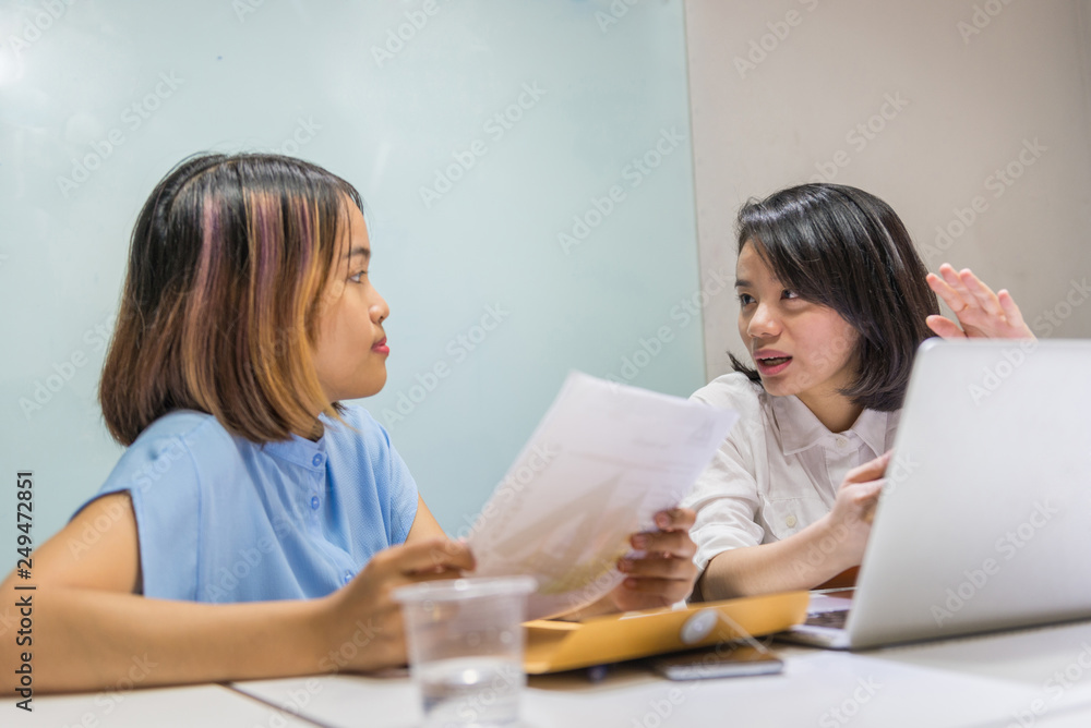 Female business colleagues discuss about work in office Female business colleagues discuss about work in office