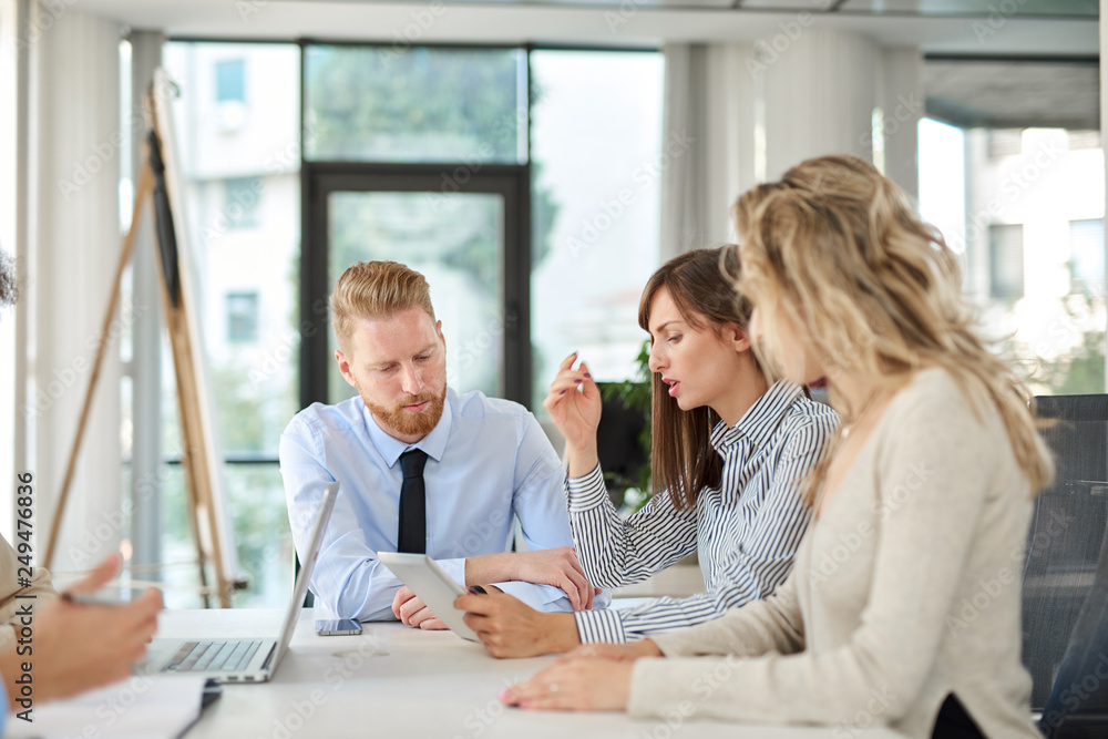 Small group of business people sitting at table and having meeting. Multi cultural group. Small group of business people sitting at table and having meeting. Multi cultural group.
