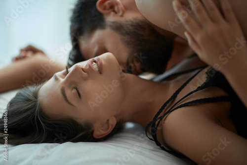 Εκτύπωση καμβά couple making love having passionate sex on bed, enjoying pleasant sensation,