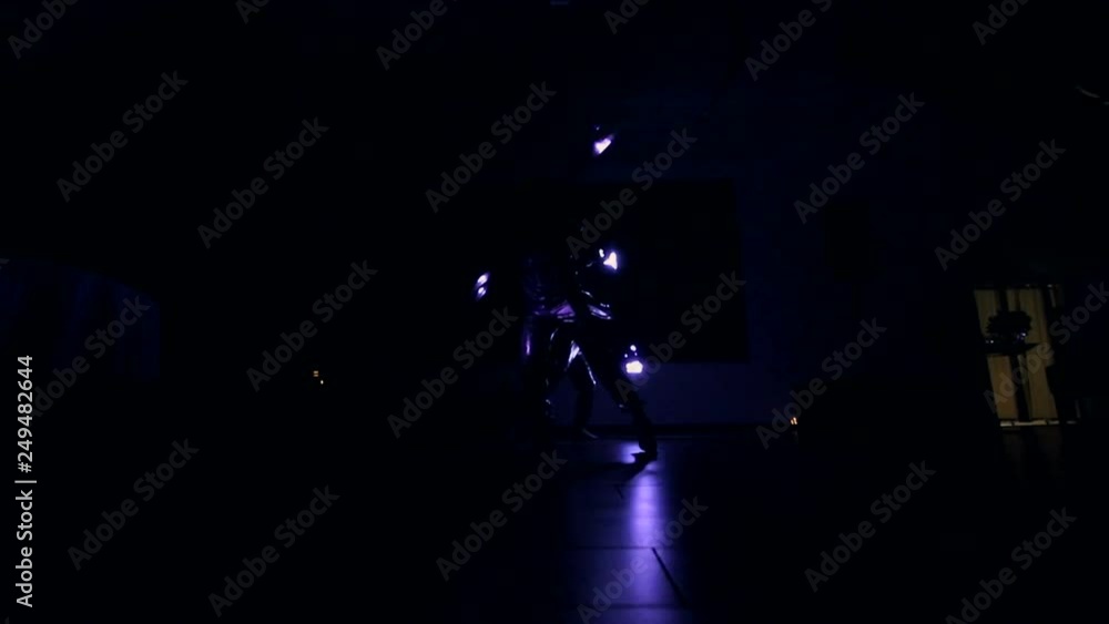 Girls dance in the dark, but they wiggle with the neon glittering sticks. Woman partying and waving pink neon tubes in darkness indoor Girls dance in the dark, but they wiggle with the neon glittering sticks. Woman partying and waving pink neon tubes in darkness indoor