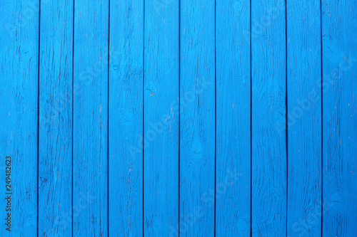 Old wooden painted boards of blue color. Vertical view. Close-up. Background. Texture.