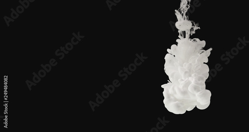White paint flowing in water isolated on black