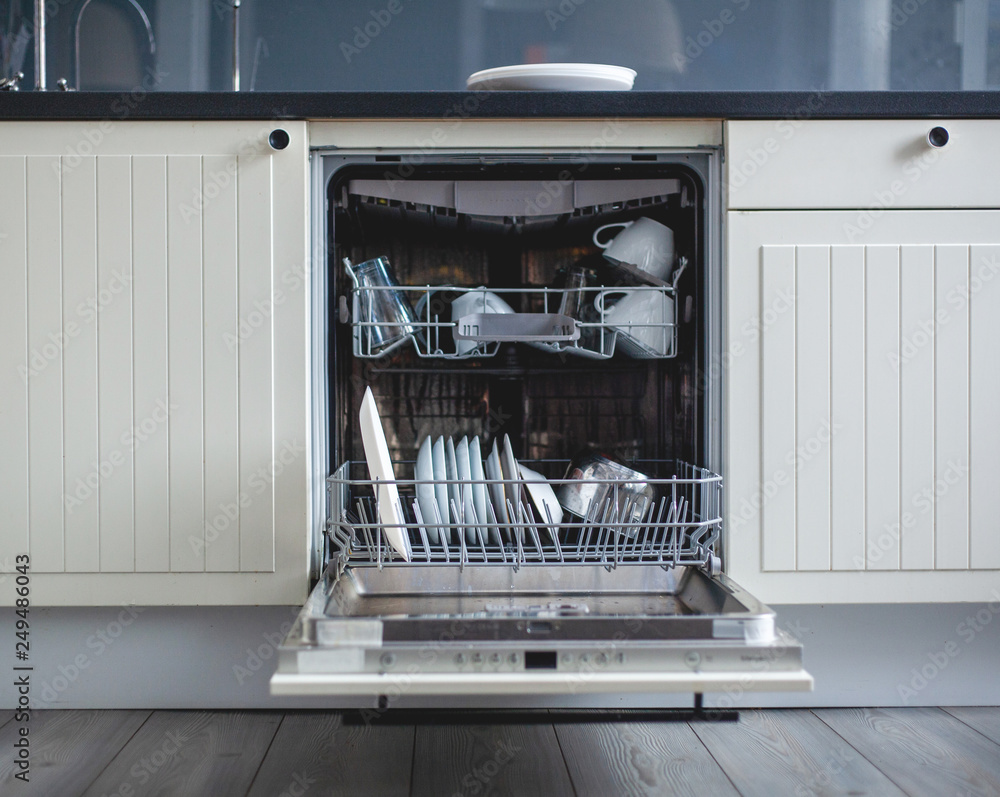 Modern kitchen. High angle view of utensils in dishwasher at kitchen Modern kitchen. High angle view of utensils in dishwasher at kitchen