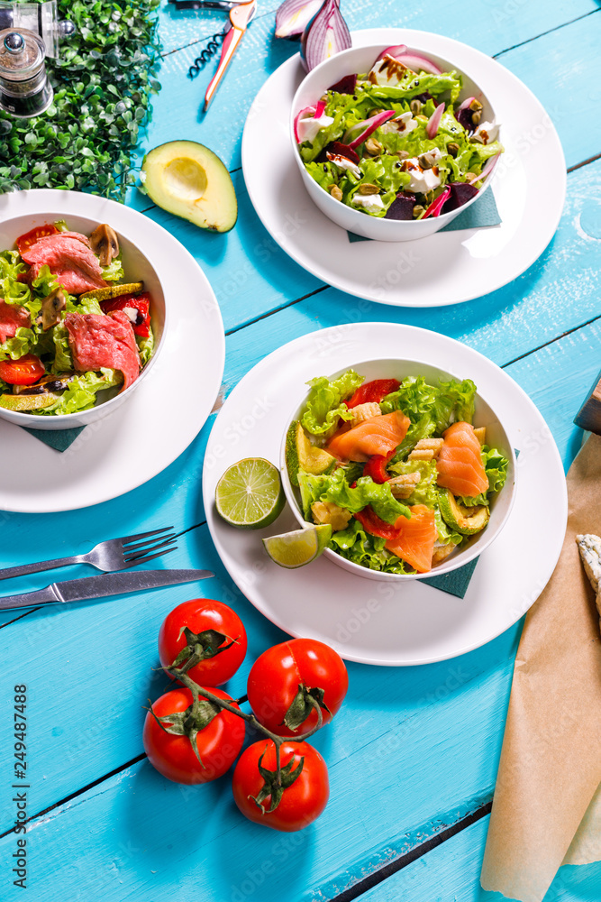 salad on a wooden blue table. salad on a wooden blue table.