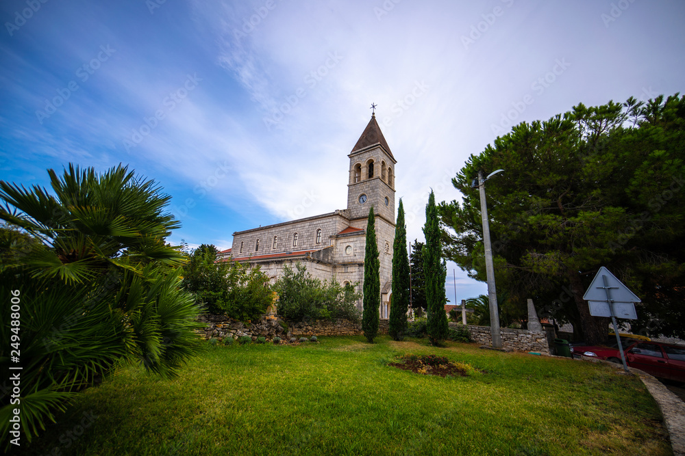 old beautiful church on an island in Croatia, Grohote church Croatia with beautiful blue sky background