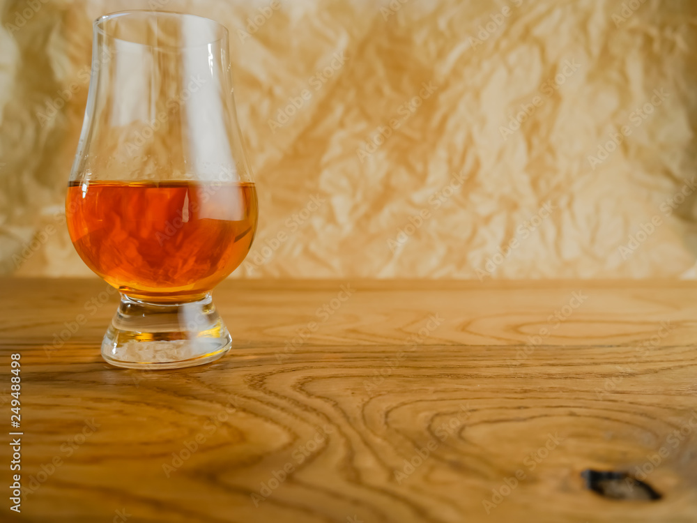 Irish Whiskey Glass on Wood and Paper Background Medium Shot Irish Whiskey Glass on Wood and Paper Background Medium Shot