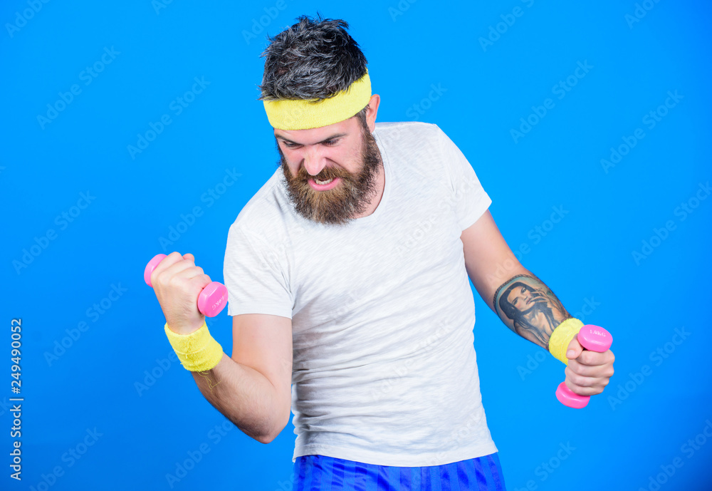 Athlete training with tiny dumbbell. Man bearded athlete exercising dumbbell. Motivated athlete guy. Sportsman training with dumbbells blue background. Improve your muscles. Use weights or dumbbells Athlete training with tiny dumbbell. Man bearded athlete exercising dumbbell. Motivated athlete guy. Sportsman training with dumbbells blue background. Improve your muscles. Use weights or dumbbells