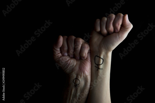 Two female hands in a fist raised up