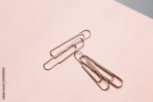 metal paper clips and paper on paper background