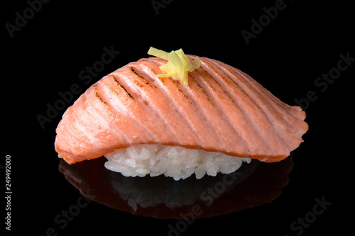 Delicious Sushi Nigiri with smoked Salmon (Sake) on black background. Traditional Japanese cuisine