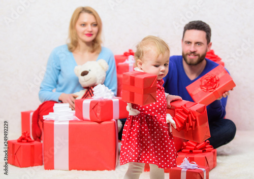 Loving everything about her. Valentines day. Red boxes. Love and trust in family. Bearded man and woman with little girl. father, mother and doughter child. Boxing day. Happy family with present box