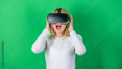 The woman with glasses of virtual reality. Woman with virtual reality headset. Happy woman exploring augmented world, interacting with digital interface. Virtuality glasses.