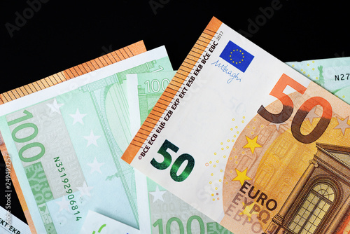 One Hundred and Fifty euro banknotes on a dark background close up