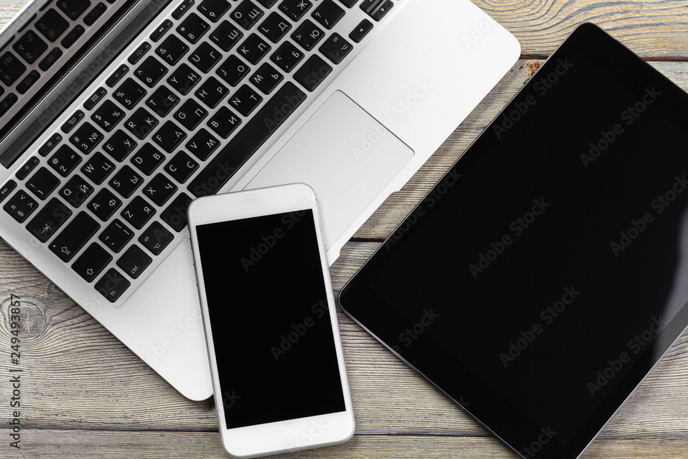 Open laptop with digital tablet and smartphone close up Open laptop with digital tablet and smartphone close up