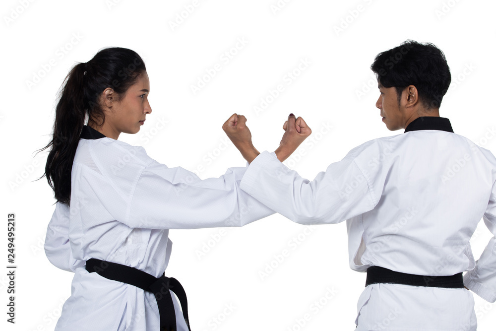 Two Master Black Belt TaeKwonDo handsome Asian Teacher man and caucasian Beautiful competitor woman fighter show hit fighting pose, self defense, studio lighting white background isolated Two Master Black Belt TaeKwonDo handsome Asian Teacher man and caucasian Beautiful competitor woman fighter show hit fighting pose, self defense, studio lighting white background isolated