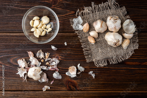 Peeled garlic on dark wooden background.