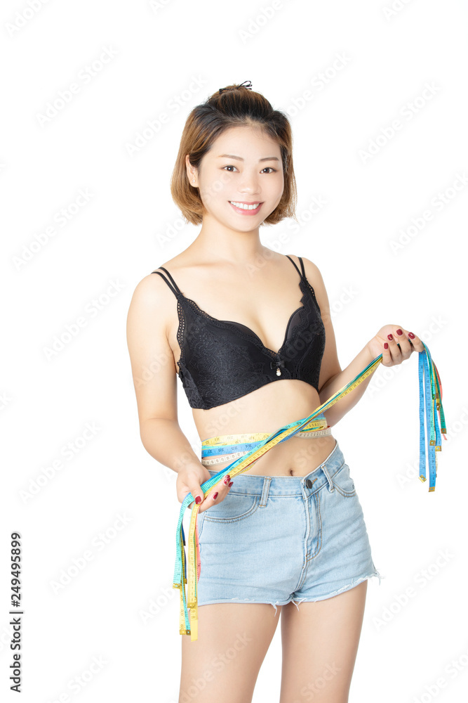 Chinese woman posing in bra and jean shorts on white background Stock Photo
