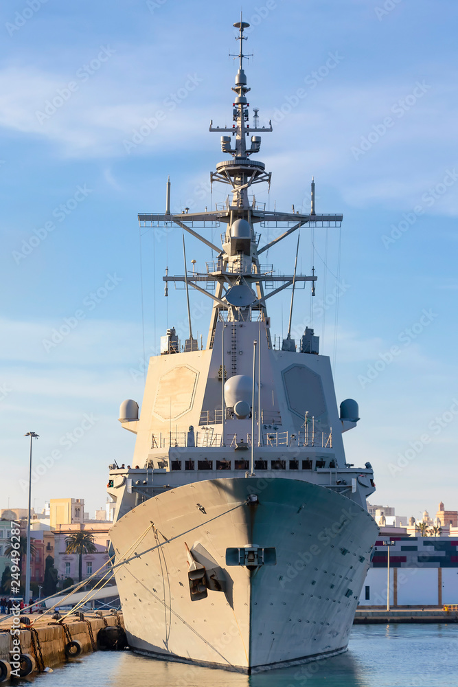 Battleship moored in the port at sunset