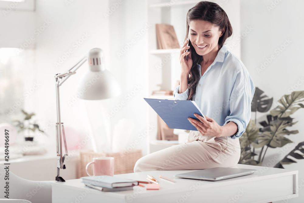 Successful prosperous self-employed woman receiving calls on monthly report Successful prosperous self-employed woman receiving calls on monthly report