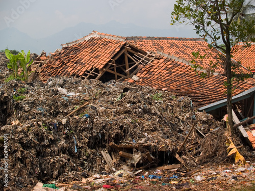 destroyed village after landslide on a dump near  cimahio, bandung, java, indonesia photo
