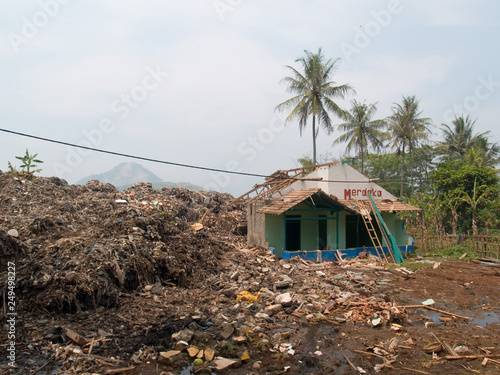 destroyed village after landslide on a dump near  cimahio, bandung, java, indonesia photo