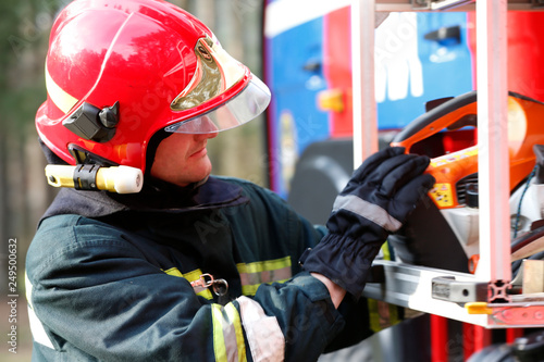  Firefighting of the forest.Firefighter retrieves fire hoses.The brave firefighter. Work of firefighter photo